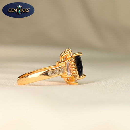 Gold ring with gemstones on a beige background, featuring Gemticks logo.