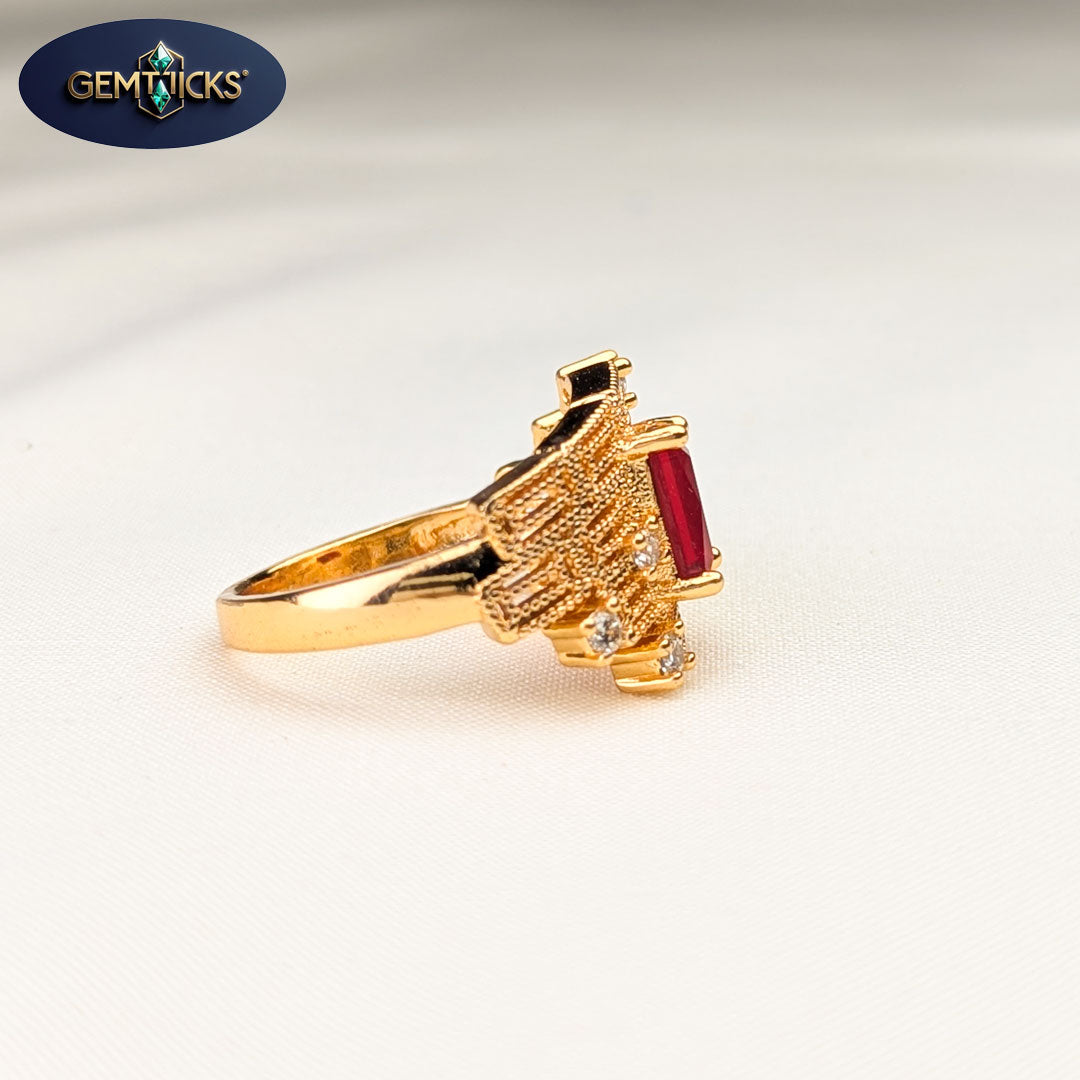 Gold ring with a red gemstone and diamonds on a light gray background, featuring the Gemticks brand.