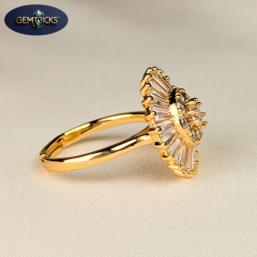 Gold ring with gemstones on a beige fabric background, featuring Gemticks logo.