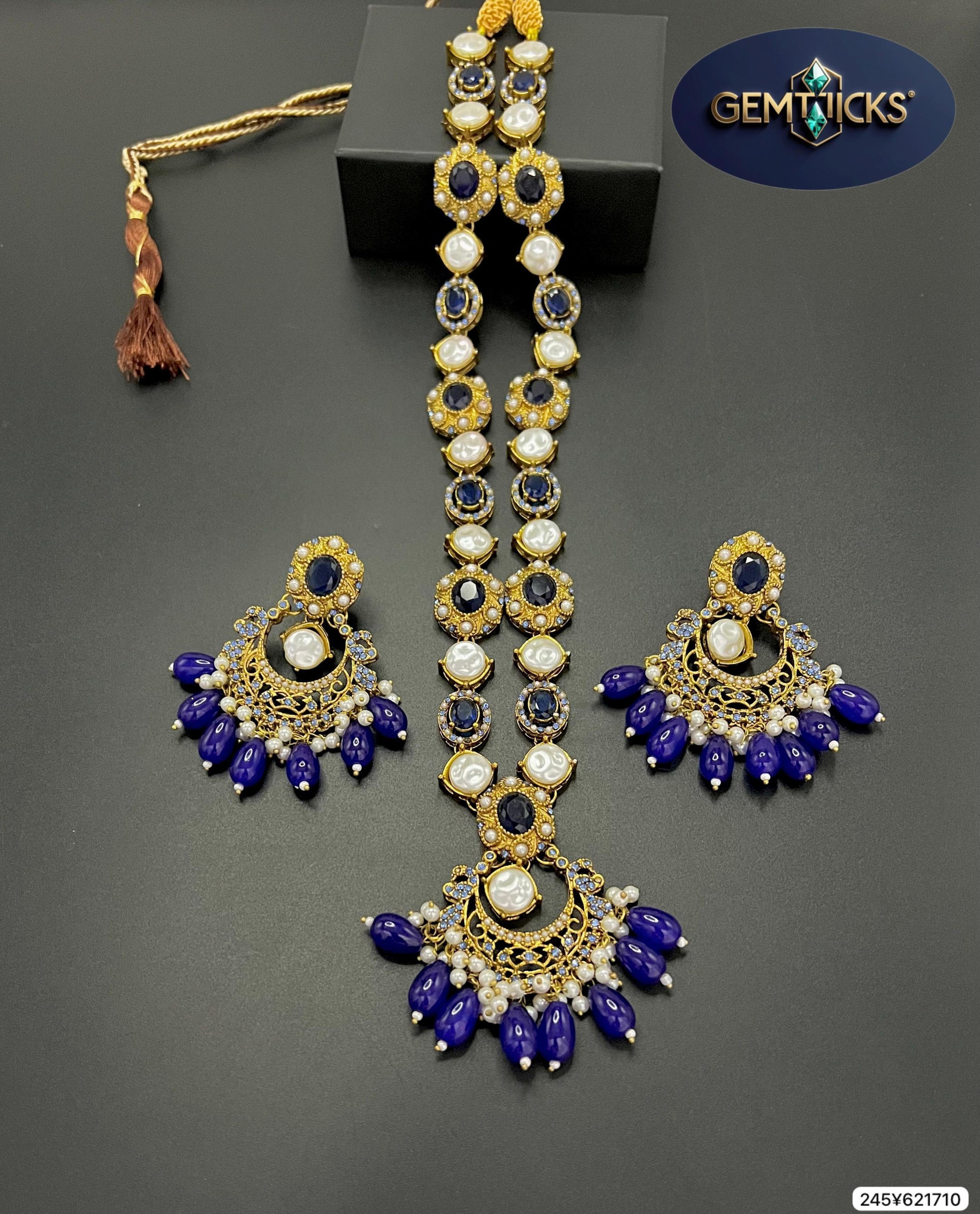 Ornate jewelry set with blue and gold elements on a dark background, featuring the GemTicks brand.