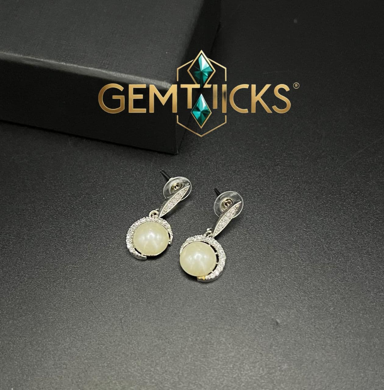 op view of Royal American Diamond stud earrings showing clear stone brilliance.