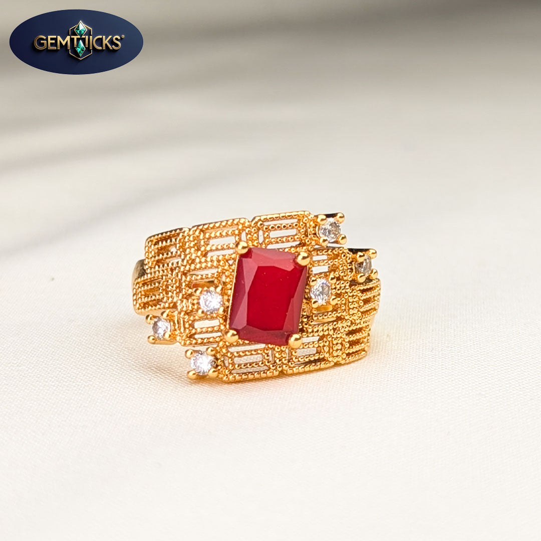 Gold ring with a red gemstone on a light background, featuring the Gemticks brand.