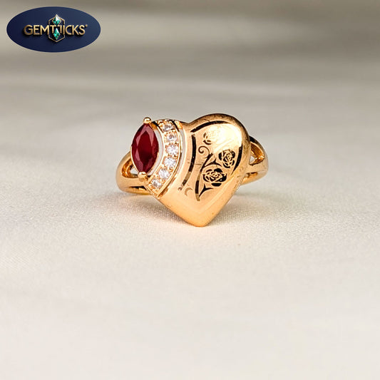Gold ring with a red gemstone and intricate design on a light background, featuring Gemticks logo.