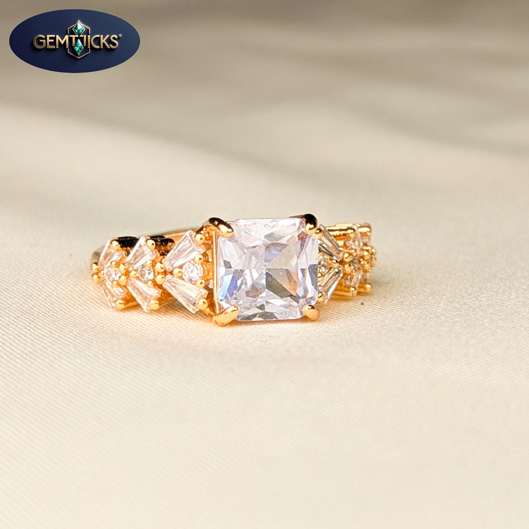 Gold ring with a large central diamond and smaller diamonds on a beige background, featuring the Gemticks brand.